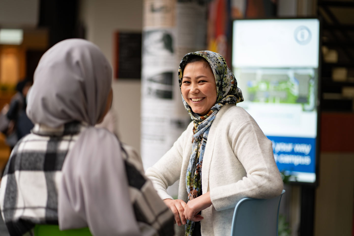 Diverse culture background students participating at TAFE and having a conversation.